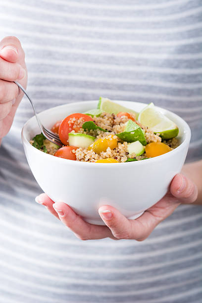 istock Woman eating quinoa salad 543577606