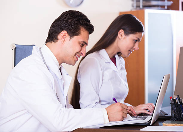 istock Family doctors with stethoscope working in office together 543577672
