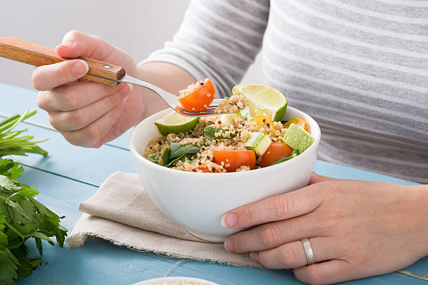 istock Woman eating quinoa salad 543577806