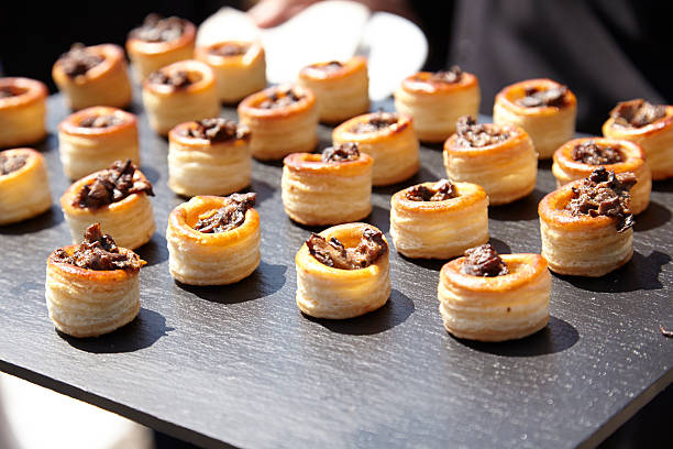 individual puff pastry wedding appetizers on a slate tray - vol au vent imagens e fotografias de stock