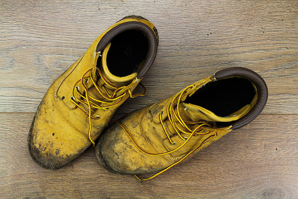 istock Muddy work boots on a wooden floor 543581640