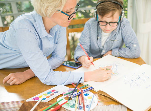istock Mother and son coloring the book 543585948