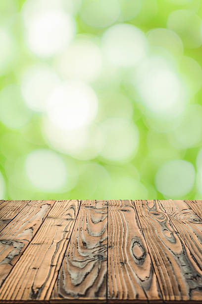 istock Wood table top on blurry green abstract background 543586580