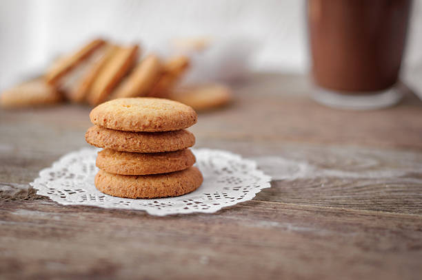 istock Butter cookies closeup  on Rustic Wooden Background with a cup 543587632