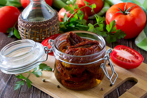 istock Sun dried tomatoes on wooden background, selective focus. 543587876