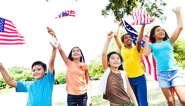 istock Group of kids wave American flags Independence Day parade 543588672