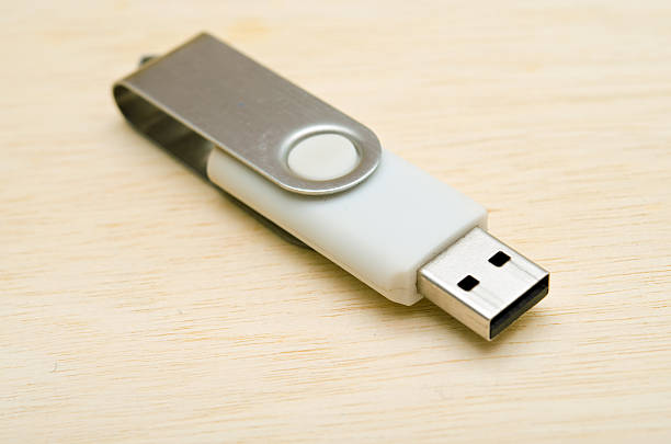 istock USB stick or USB thumb drive isolated on wooden board 543589132
