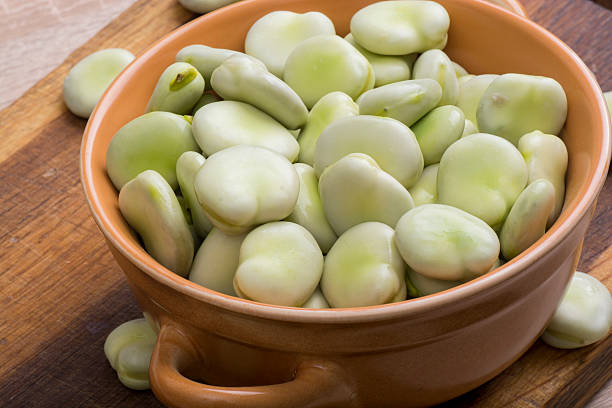 Fresh broad beans in bowl stock photo