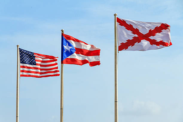 Flags Puerto Rico Flags of the Old Spanish military (Cross of Burgundy), Puerto Rico and America at fort San Cristobal in San Juan, Puerto Rico puerto rican culture stock pictures, royalty-free photos & images