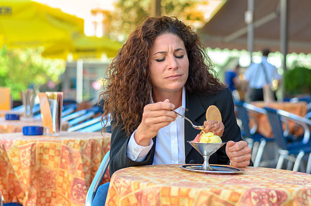 istock Attractive woman savoring an ice cream sundae 543591606