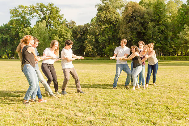 istock Friends playing Tug of war in a park - Teamwork 543593264