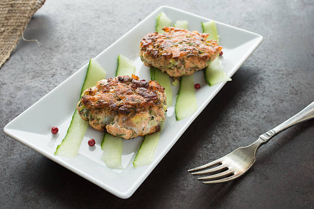 istock Salmon cutlet on cucumber and red pepper 543593396