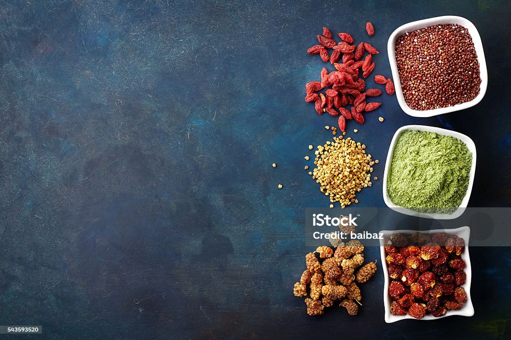 Various healthy superfoods Various superfoods on old blue background. Top view Goji Berry Stock Photo