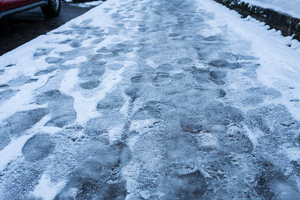 Sidewalk with footprints in the snow and slush