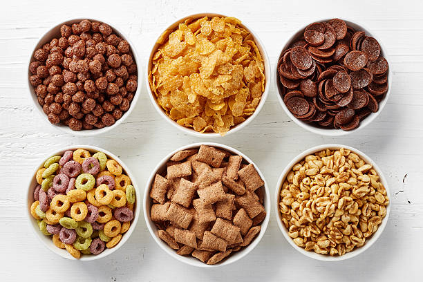 Bowls of various cereals Bowls of various cereals from top view corn flakes stock pictures, royalty-free photos & images