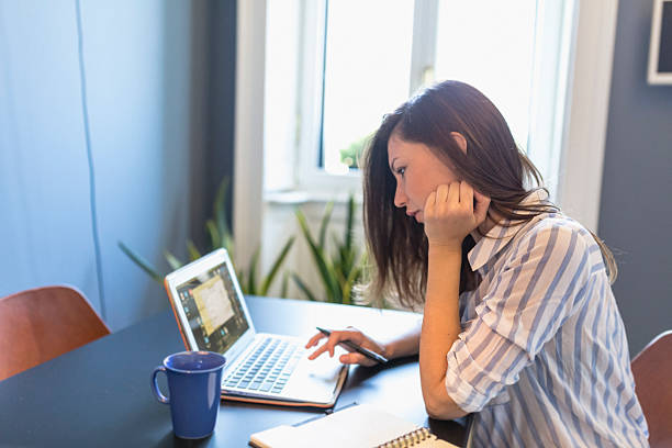 istock Woman is using laptop at home 543595460