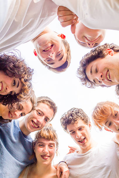 istock teenagers in circle looking down at camera 543595764