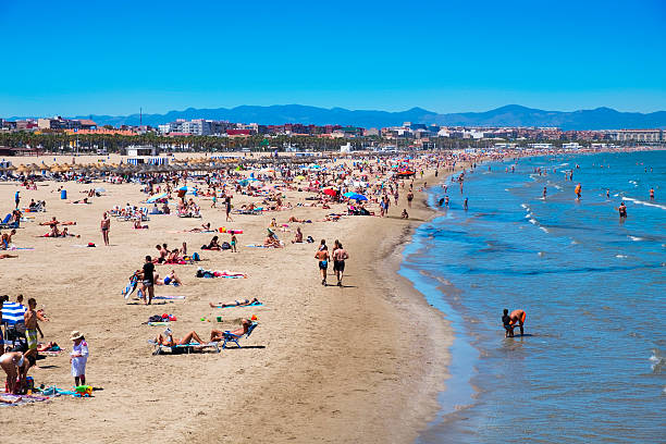Valencia, Spain - June 22, 2016: Sunbathers at El Cabanyal and La Malvarrosa beaches in Valencia, Spain. These are the main beaches in the capital of the Valencian Community