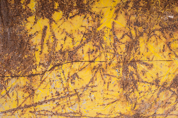 istock Yellow metal with rust and scratches 543596934