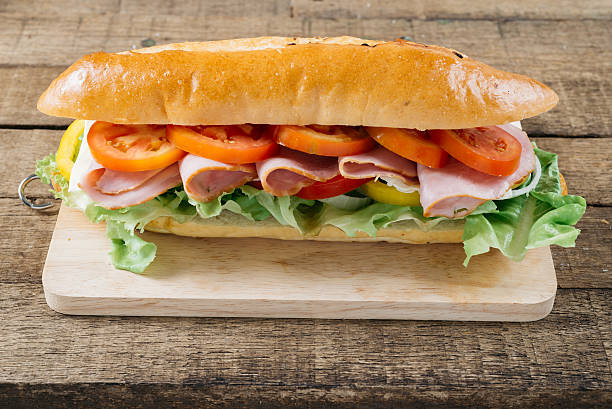 istock Food series : Baguette ham sandwich on wooden board 543597818