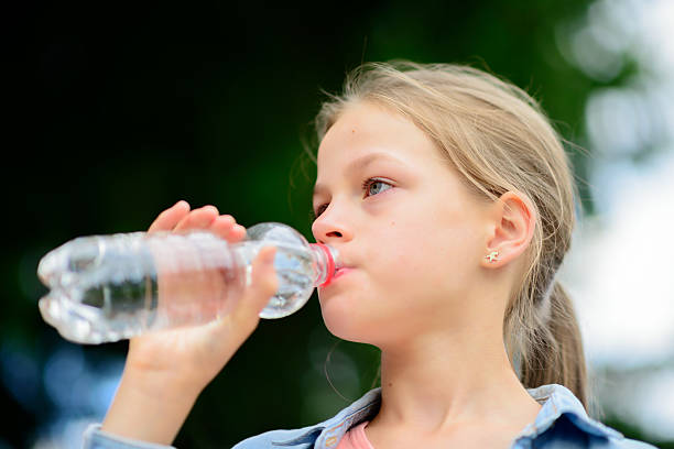istock Girl drinking water outdoors 543599254