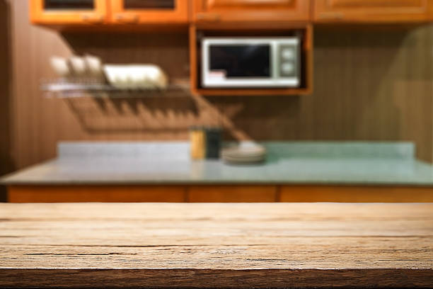 istock Wood desk space and blurred of kitchen background. 543600062