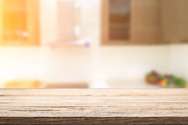 istock Wood desk space and blurred of kitchen background. 543600148