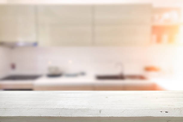 istock Wood desk space and blurred of kitchen background. 543600306