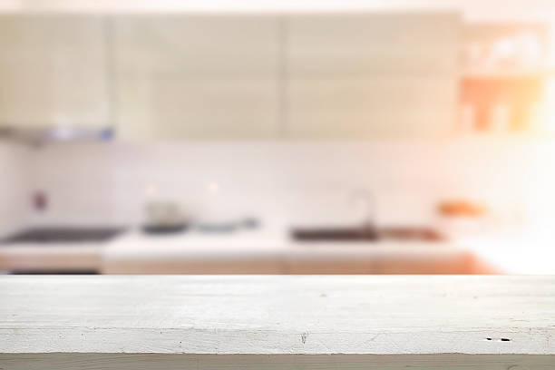 Wood desk space and blurred of kitchen background. stock photo