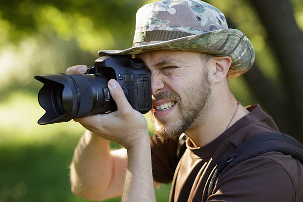 istock Photographer shooting with DSLR camera in forest 543600374
