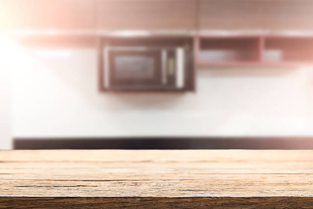 Wood desk space and blurred of kitchen background. stock photo
