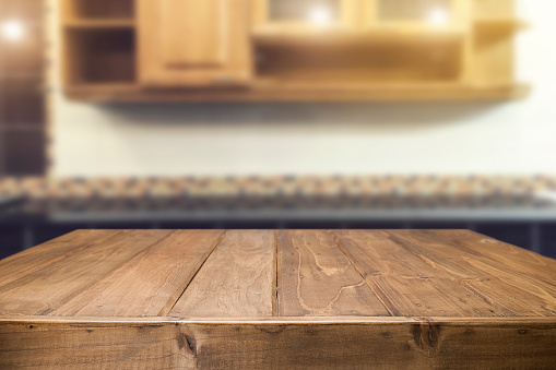 Wood desk space and blurred of kitchen background. for product display montage. business presentation.Wood desk space and blurred of kitchen background. for product display montage. business presentation.
