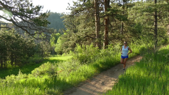 Young woman morning trail run Bear Creek Colorado Rocky Mountains