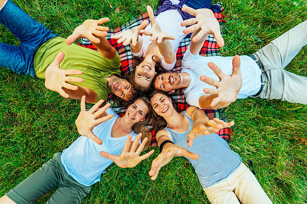 istock Young beautiful people relaxing in park and waving 543652126
