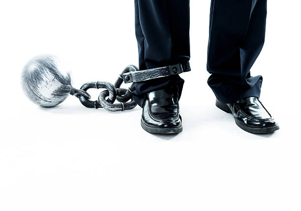 istock Businessman standing with ball and chain 543652632