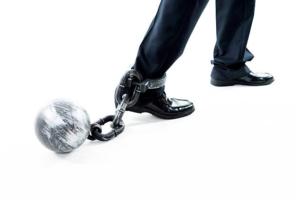 istock Businessman walking with ball and chain 543652674