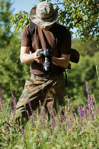 istock Photographer shooting flowers with DSLR camera in forest 543652678