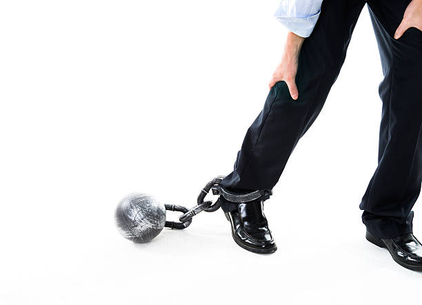 istock Businessman walking with ball and chain 543652722