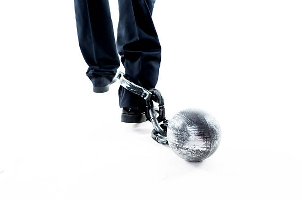 istock Businessman walking with ball and chain 543652764