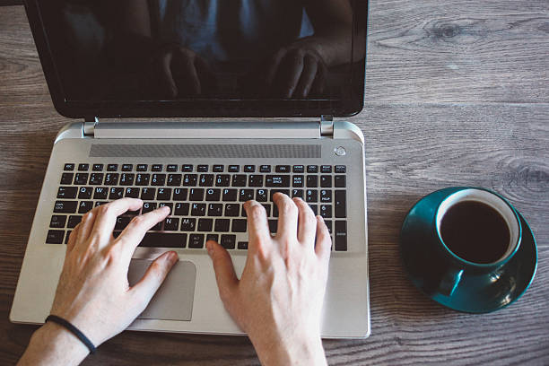 istock High angle view of a young man using laptop 543656106