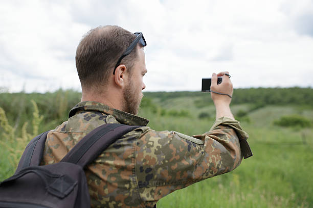 istock Photographer shooting field with compact camera outdoor 543657042