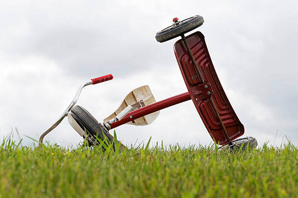 istock Tipped Over Tricycle in Grass 543657492