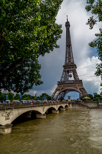Paris, France - June 17, 2016: A shot of the world famous Eiffel Tower during the EUFA Euro Football Tournament 2016.  You can see the tower has been decorated in a football theme, and at the far end there is one of the fan parks where supporters can watch the matches live.