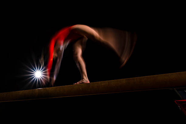 istock Gymnast flipping on balance beam 543657634
