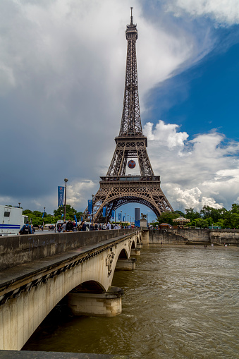 Paris, France- June 17, 2016: A shot of the world famous Eiffel Tower during the EUFA Euro Football Tournament 2016.  You can see the tower has been decorated in a football theme, and at the far end there is one of the fan parks where supporters can watch the matches live.