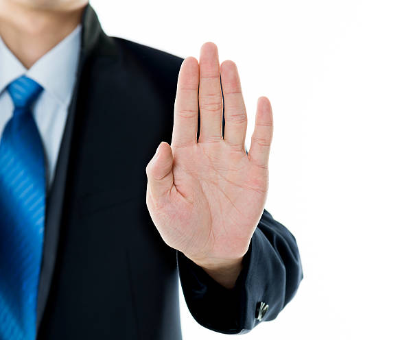 istock Businessman show STOP against white background 543658078