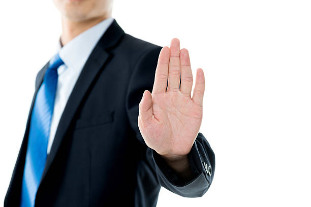 istock Businessman show STOP against white background 543658130