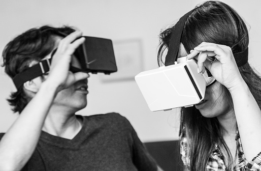 A young Japanese Students Enjoying Virtual Reality Console at a Cafe in Kyoto, Japan.