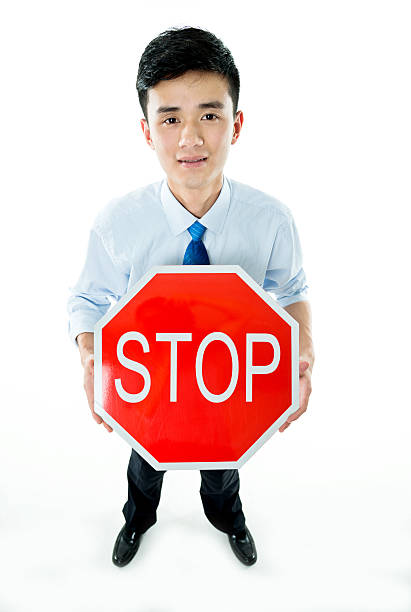 istock Young businessman holding STOP sign 543659802