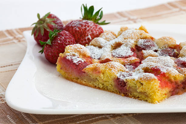 istock Sugared sponge pie with strawberry on plate 543659994